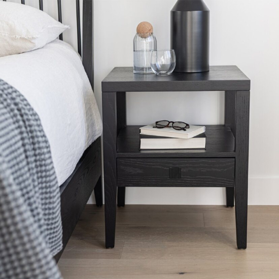 Hara 1 Drawer Accent Table in Black beside Bed