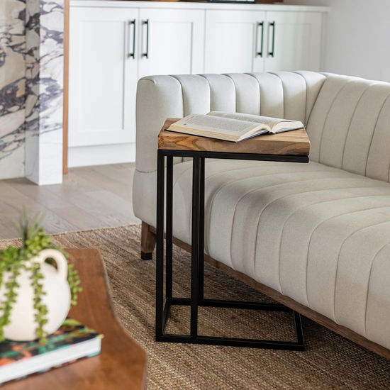 Natura C Table Natural – Sofa Side View Natura C Table tucked beside a sofa in a living room